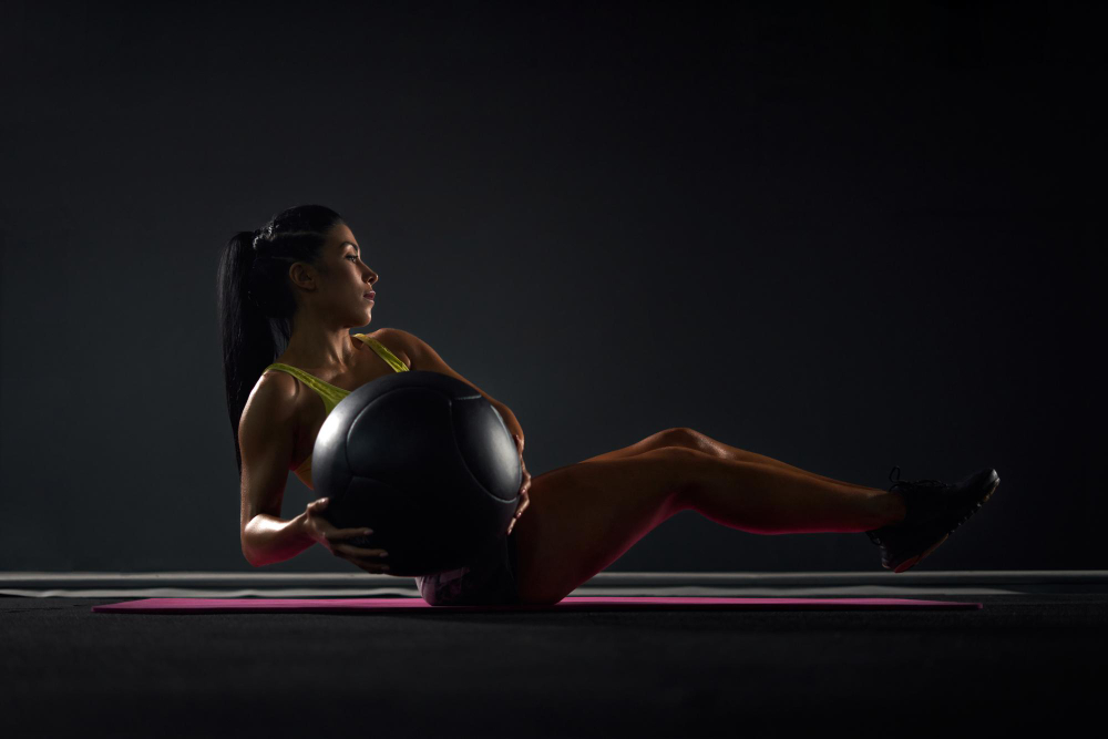 sportswoman-training-abs-with-ball-gym
